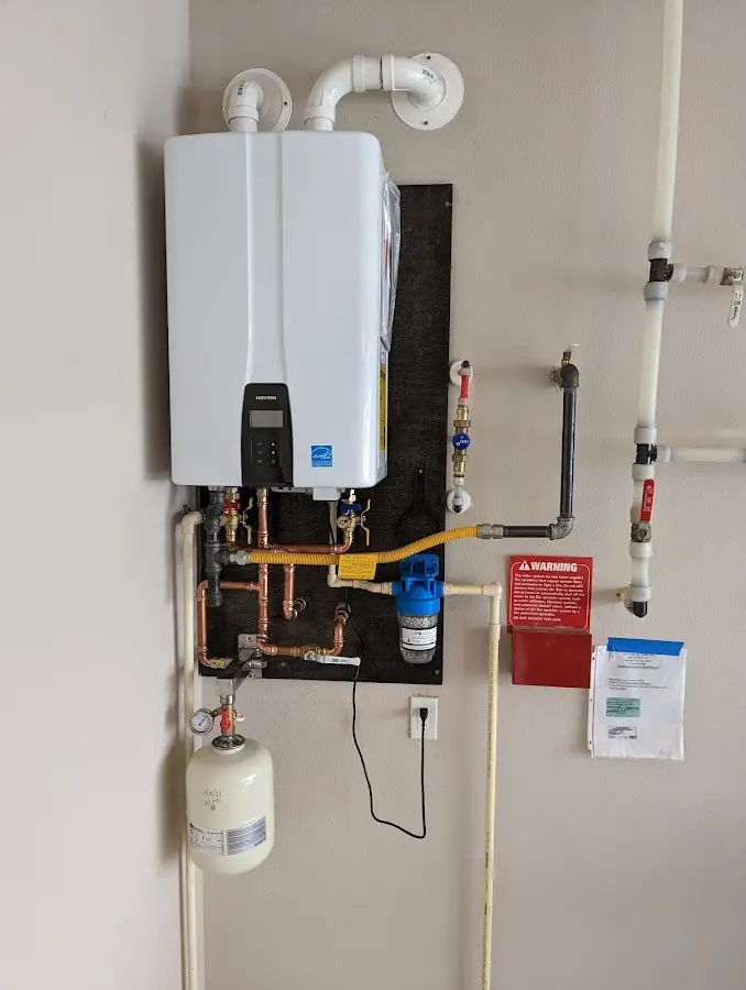 Professional plumber installing copper piping in a North Palm Beach home